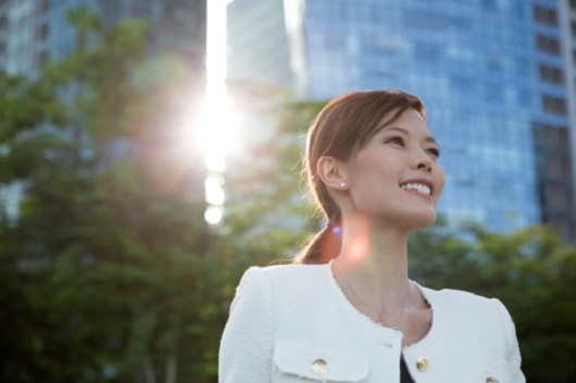 Executive Chinese woman smiling in city