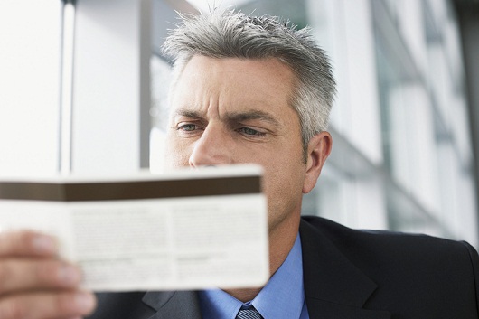 Businessman holding plane ticket