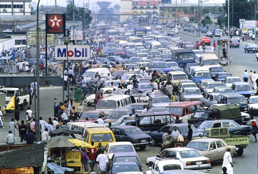 In an almost daily routine, cars line up for gasoline in Port Harcourt. The most enterprising drivers go the wrong way on a divided highway to be in a shorter line. At the time this photo was taken Nigeria was importing the majority of it's deisel and gasoline from Cameroon, as it was easier for corrupt officials to skim profits from imports than to run a refinery.