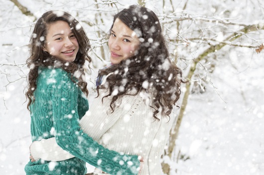 Teenage sisters (16-17) playing in snow