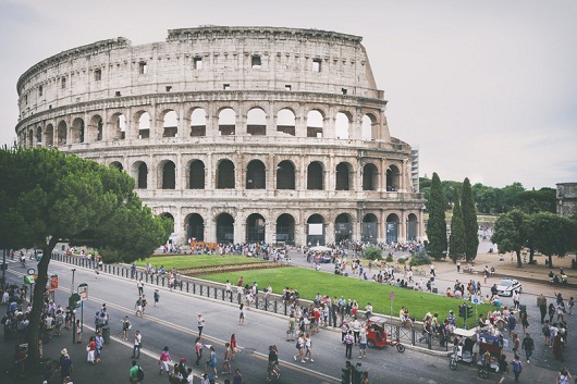 Tourists around the Colosseum (Flavian Amphitheatre) in Rome, Italy. The Colosseum was constructed in the 1st century AD.