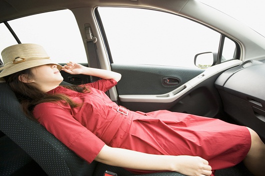 A woman taking a rest in a car