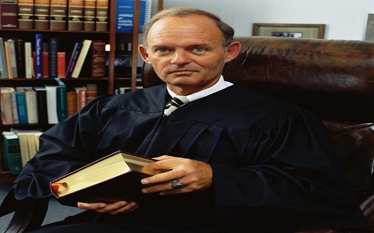 Judge Holding Book in His Office