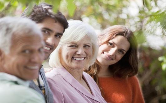 Family smiling together outdoors